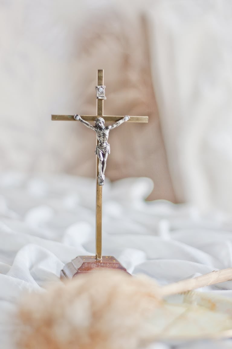 A brass crucifix featuring Jesus Christ, symbolizing faith and devotion.