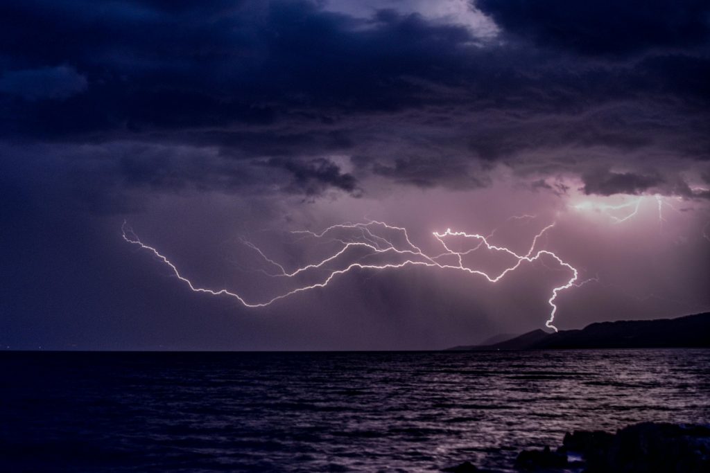 Storm and lightning above the sea water