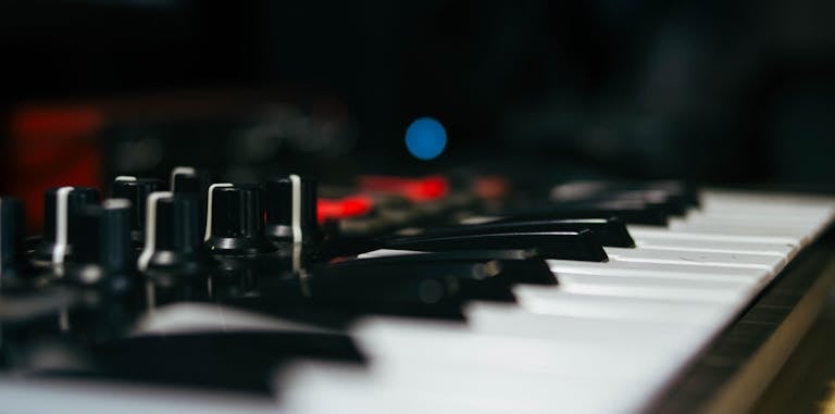 Detailed view of an electronic keyboard and control knobs.
