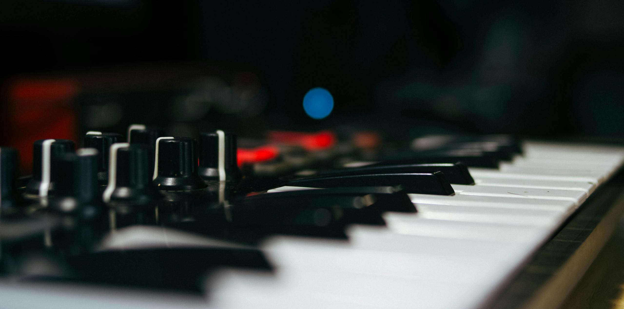 Detailed view of an electronic keyboard and control knobs.